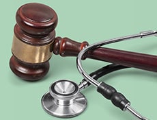 Gavel and stethoscope on background